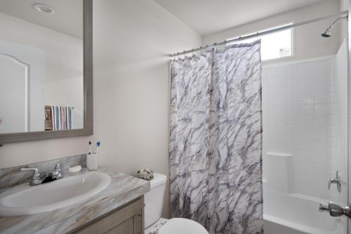 A bathroom with a marble shower curtain.