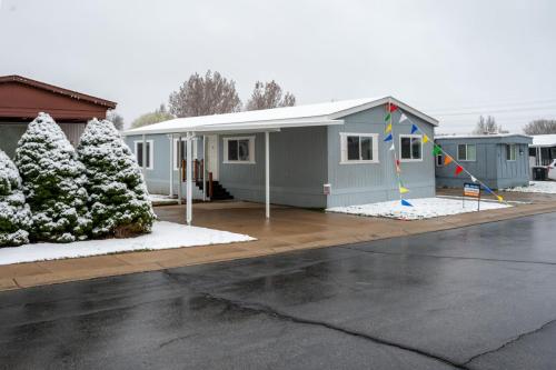 A mobile home is covered in snow on a snowy day.