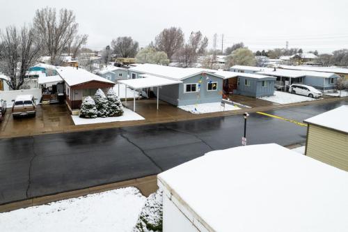 An aerial view of a mobile home park in the snow.